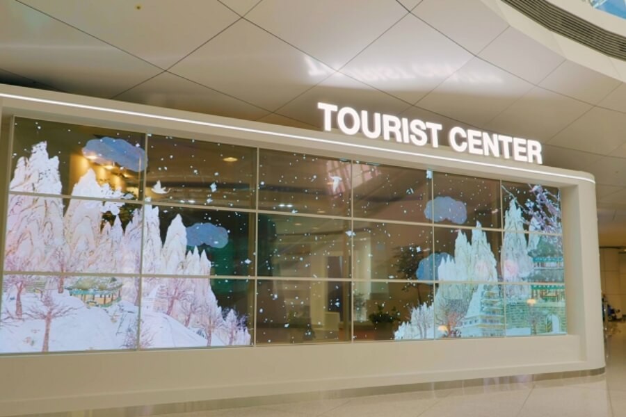 Transparent OLED display used as a daylight visible alternative to outdoor projection screens