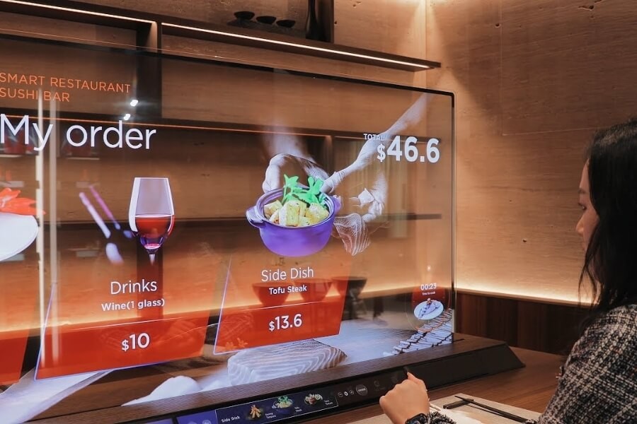 High-end hotel bedroom with transparent OLED embedded in bed frame, offering entertainment and sleep report functions