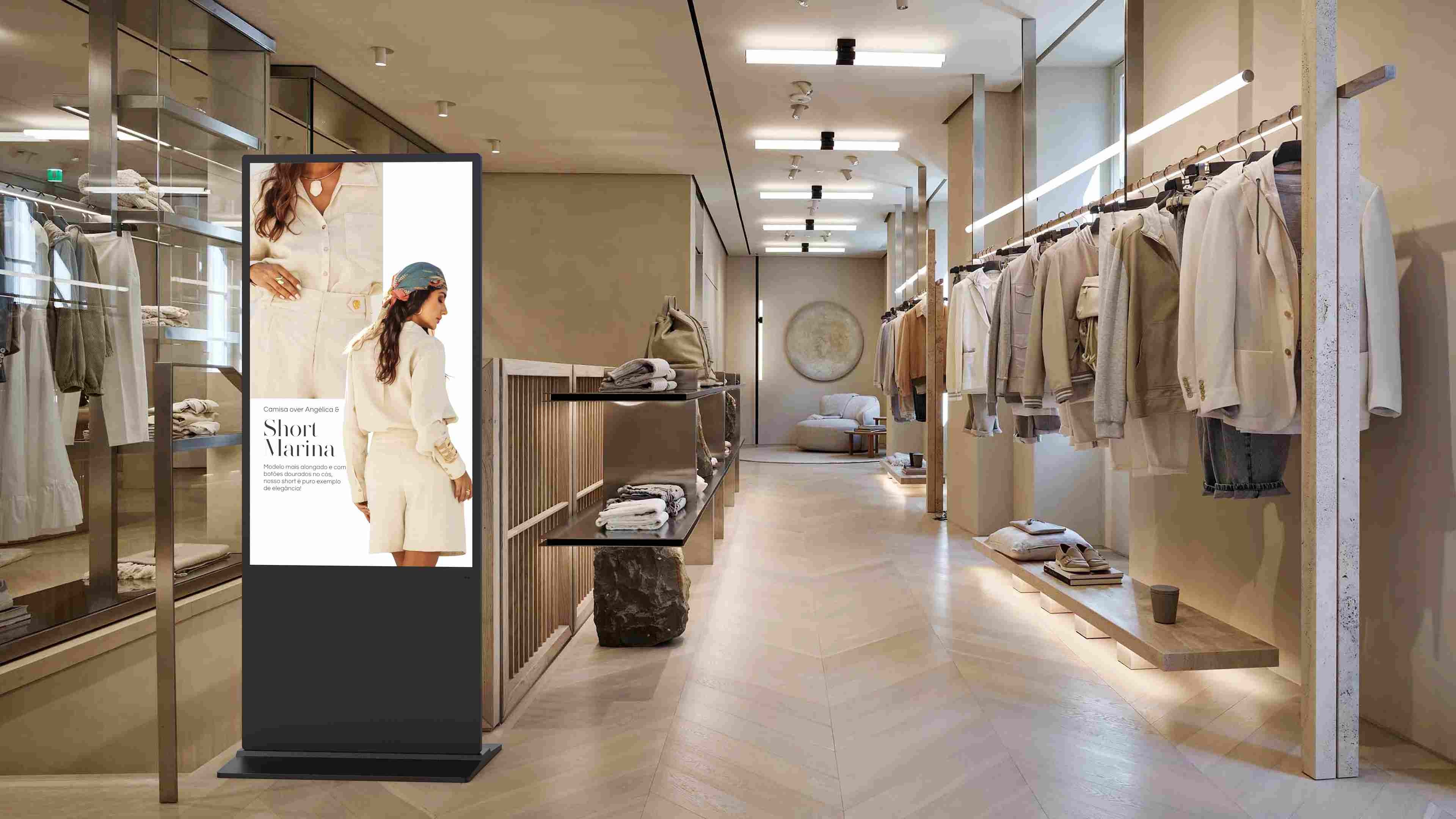 Vertical indoor LCD display kiosk showing high-definition retail media in an apparel store, illustrating everyday LCD screen applications.