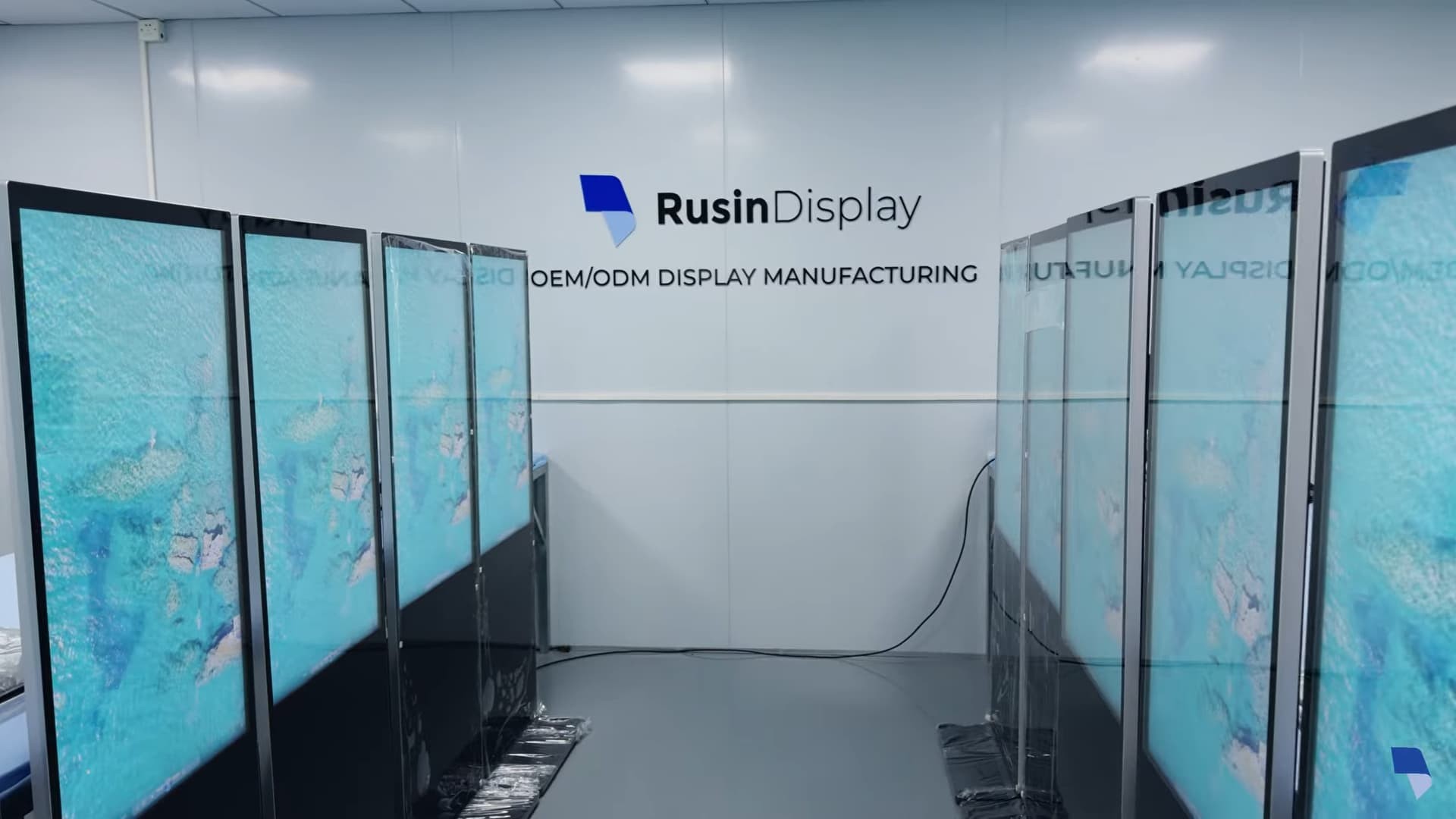 55-inch freestanding digital signage units undergoing burn-in and functional testing